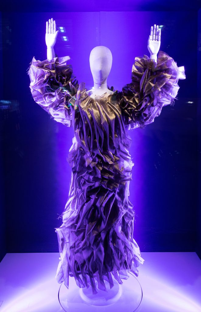 The mannequin in the display with arms raised