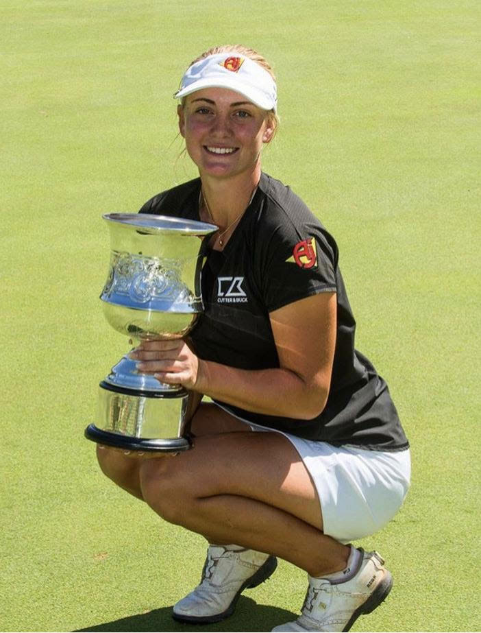 Julia Engstrom holding a winners trophy