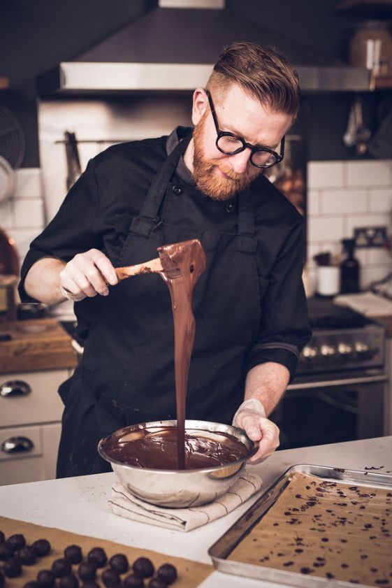 Paul A Young heating chocolate in a steel bowl