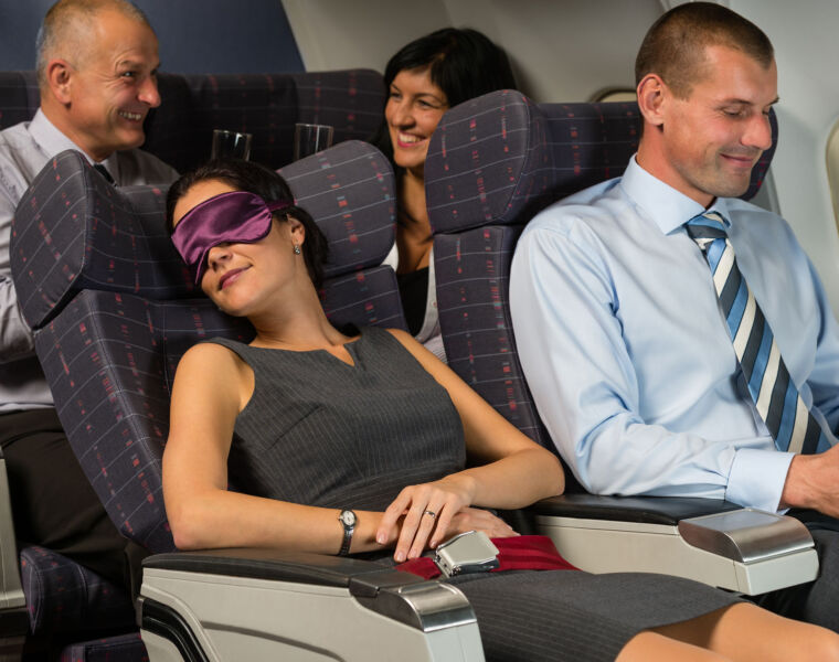 A woman sleeping on a plane