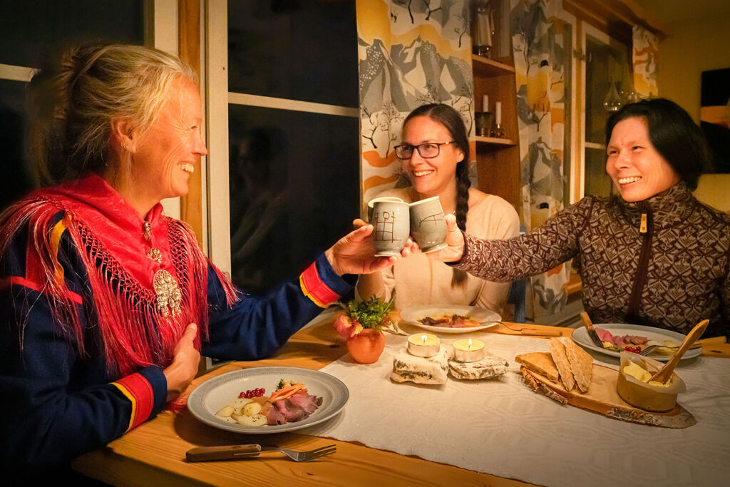 People enjoying an authentic Sami dinner