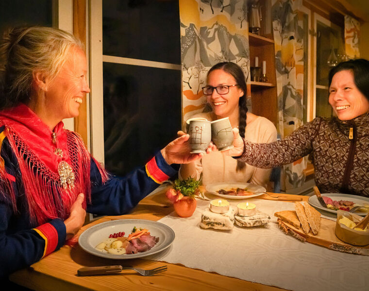 People enjoying an authentic Sami dinner