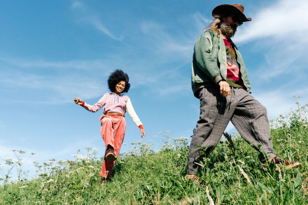 Male and female model walking through the countryside