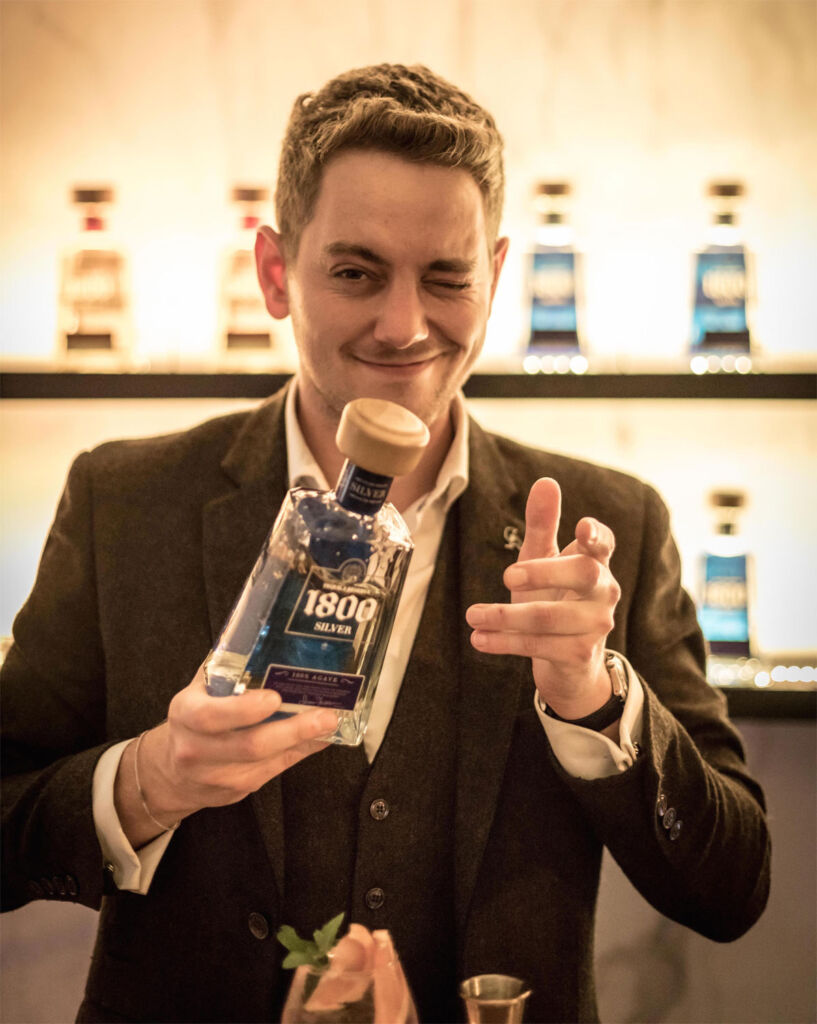 Oliver Pergl holding a bottle of 1800® Silver Tequila
