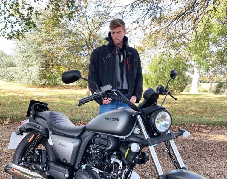 Young man admiring the Sinnis Hoodlum 125cc