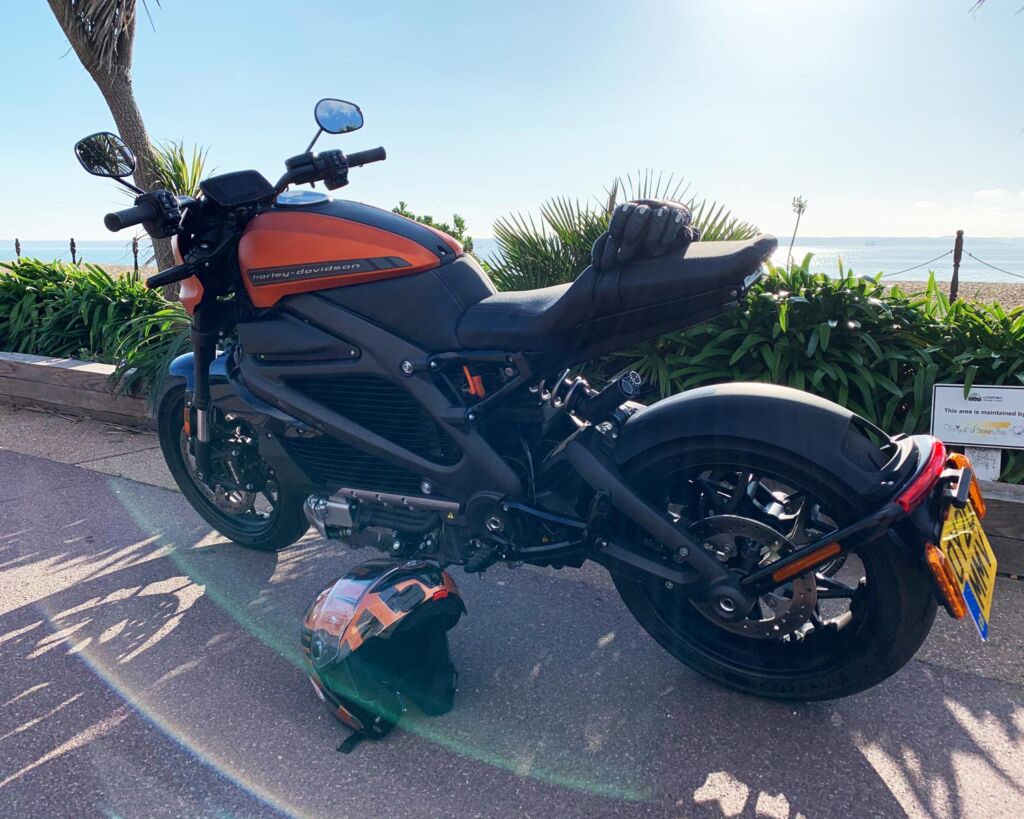A side view of the motorcycle parked at the seafront