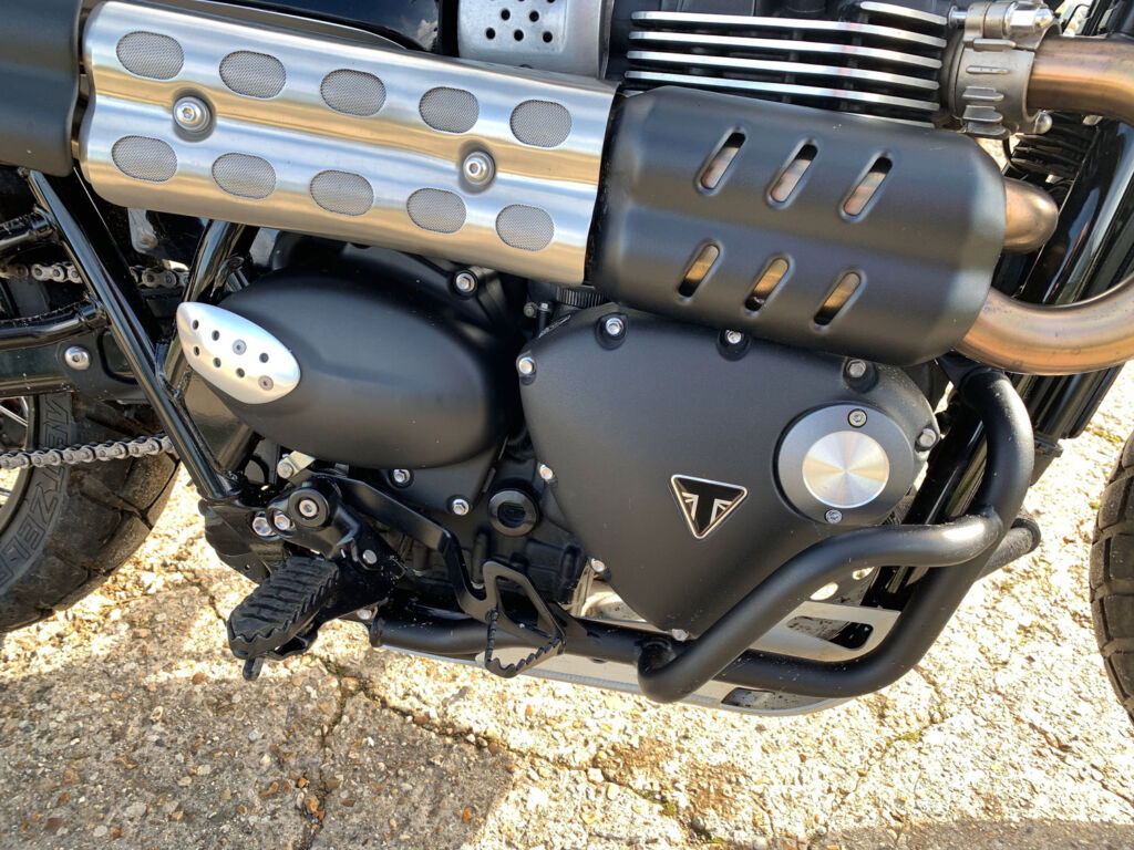 A closeup view of the bikes engine and exhaust