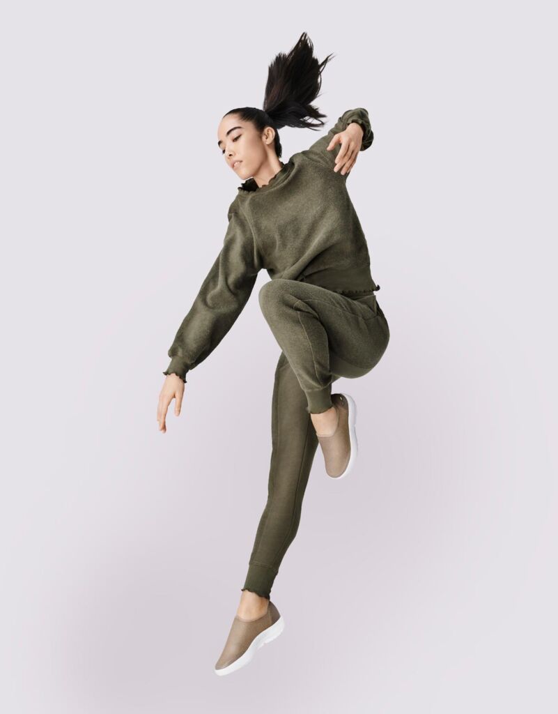 An energetic dancer wearing OOFOS shoes