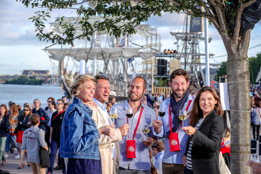 Happy people tasting bordeaux wines by a traditional tall ship . Photograph by G.Bonnaud.