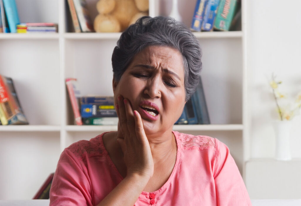 An older woman suffering from toothache