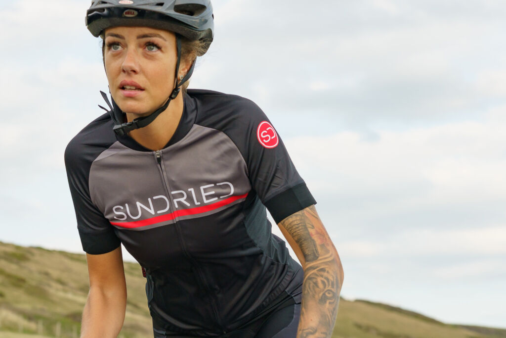 A woman out riding in the countryside wearing Sundried cycle clothing