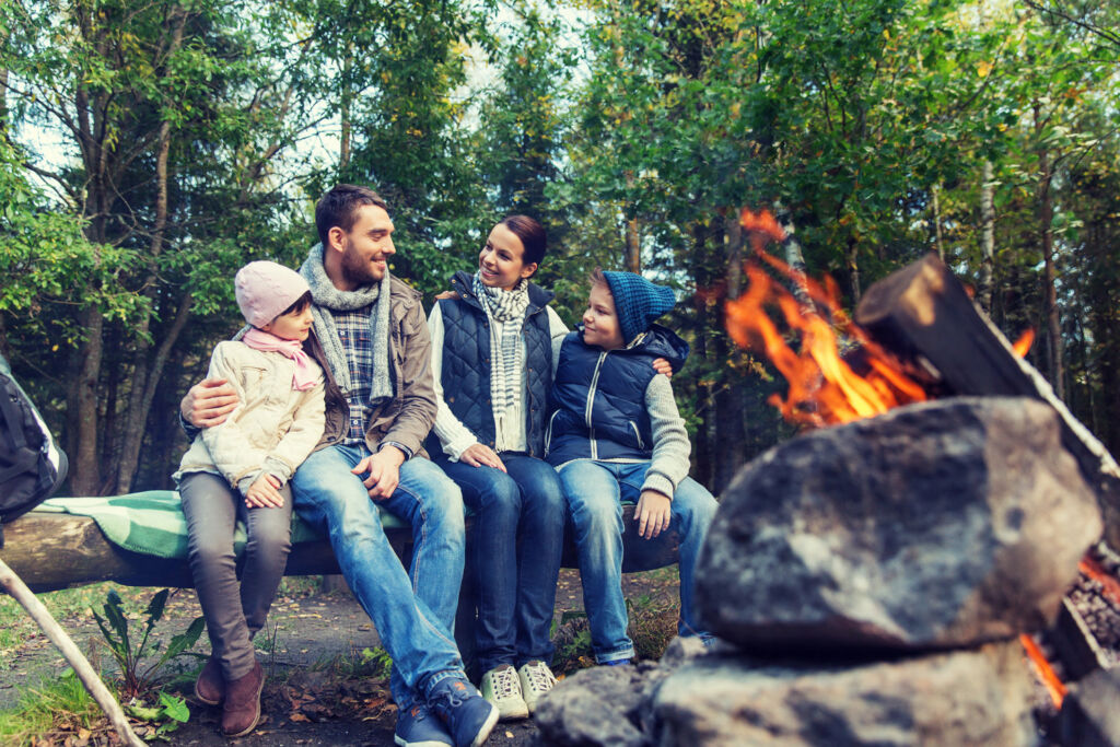 A family enjoying some Eco-Camping by a fire