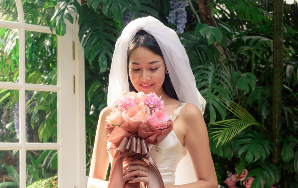 A young bride admiring her bouquet of flowers