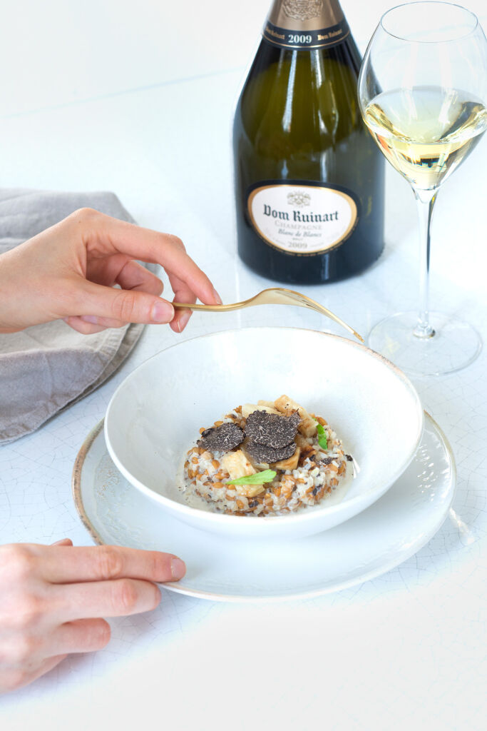 Someone enjoying an expertly prepared food dish with a bottle