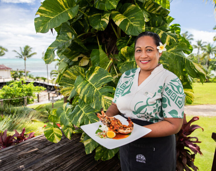 A waitress serving lobster at Sinalei Resort in Samoa