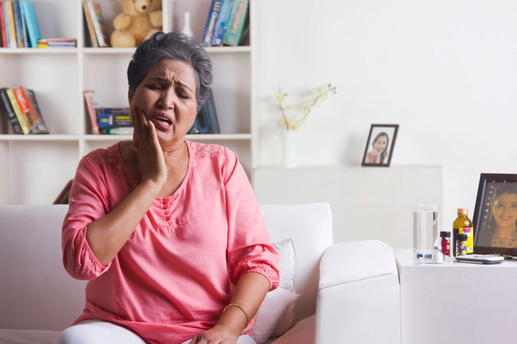 An older woman trying to cope with the pain of toothache
