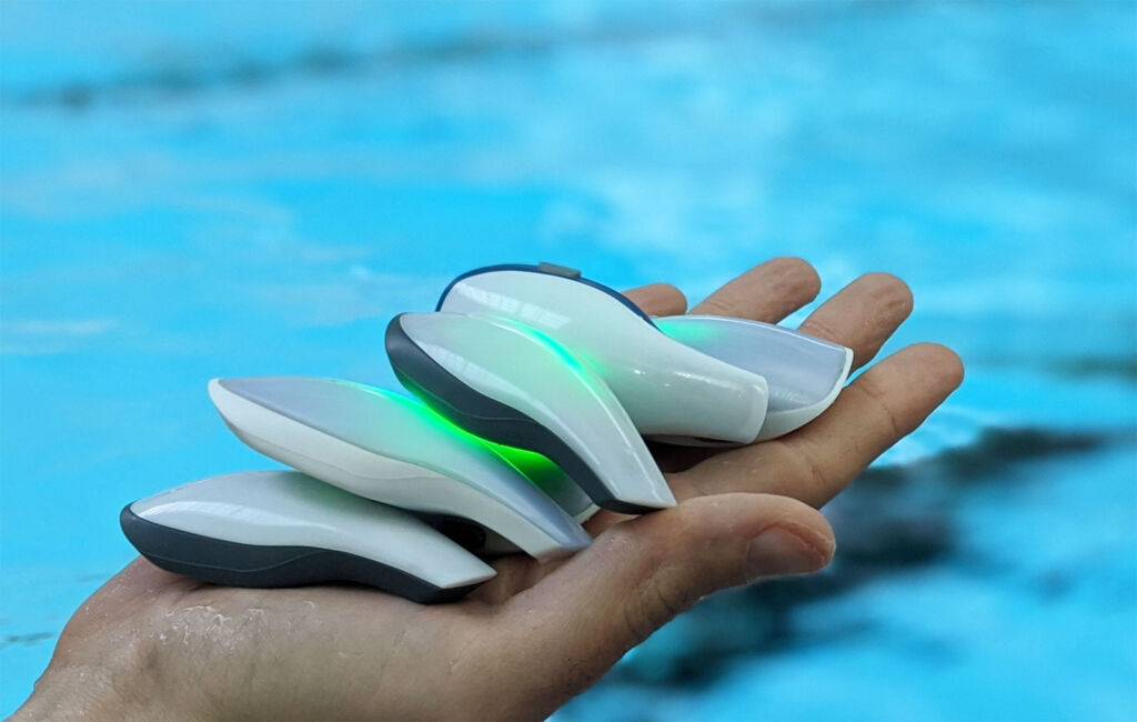 The wearable (which floats) being held in the hand