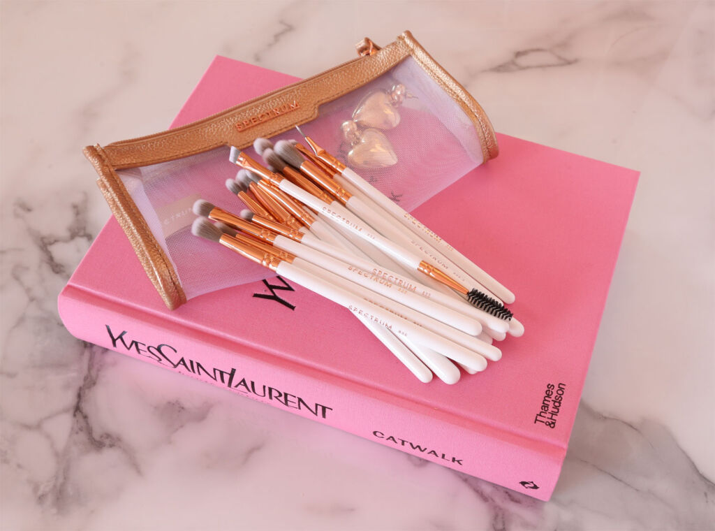 Spectrum Make up brushes with a clear case on a book