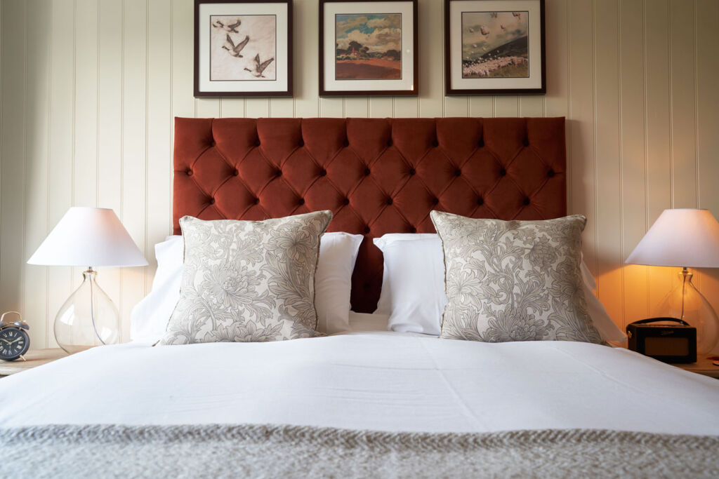 One of the inviting beds at the Inn which has been beautifully decorated with cushions