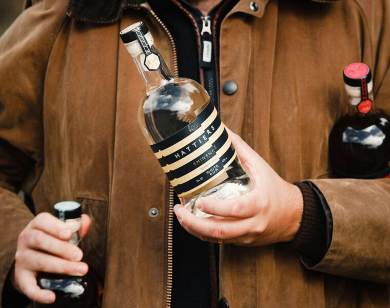 A man carrying a few bottles of Hattiers Rum