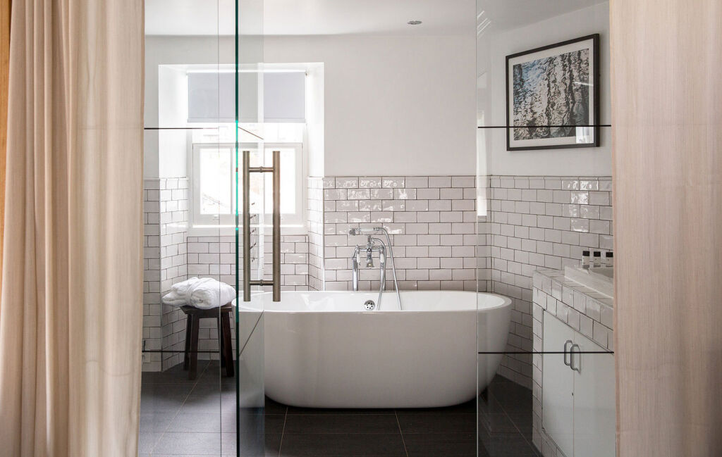The bathroom with clear glass wall