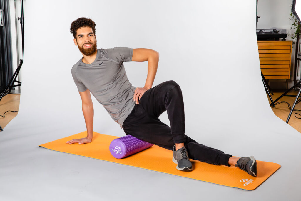 A young man posing for a photographer on some Meglio fitness products