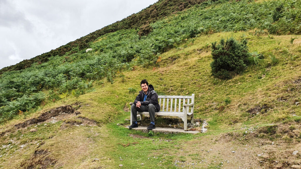 Paul taking a few minutes out to enjoy the views on a wooden bench