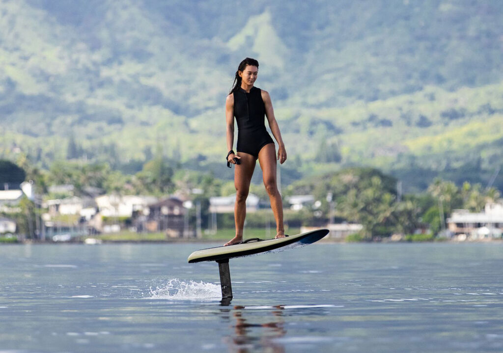 A woman experiencing the sensation of flying over the water