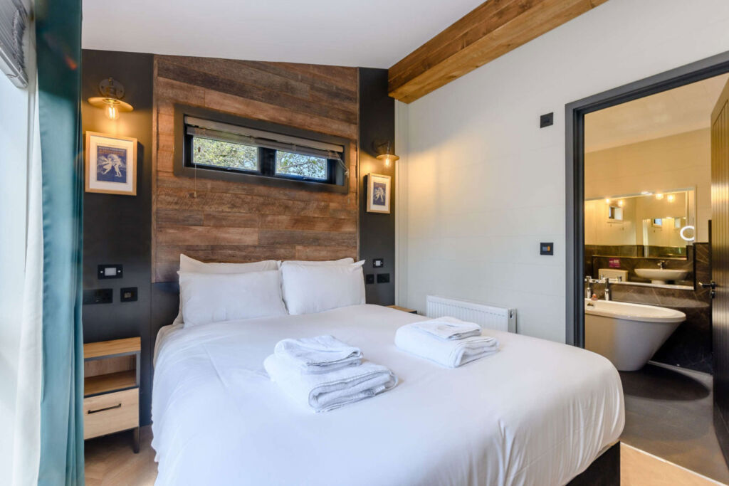 Inside one of the lodge bedrooms with its luxury en-suite bathroom with freestanding rolled top bath
