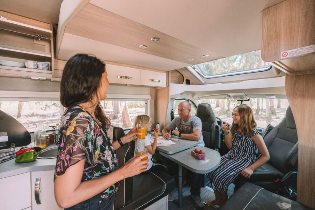 Family eating breakfast inside one of the company's Atlas campers