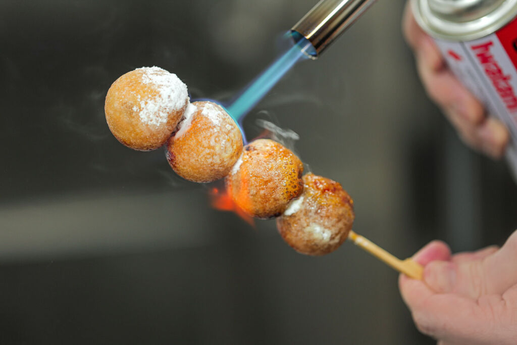 Fish balls getting a hot blast with a blowtorch