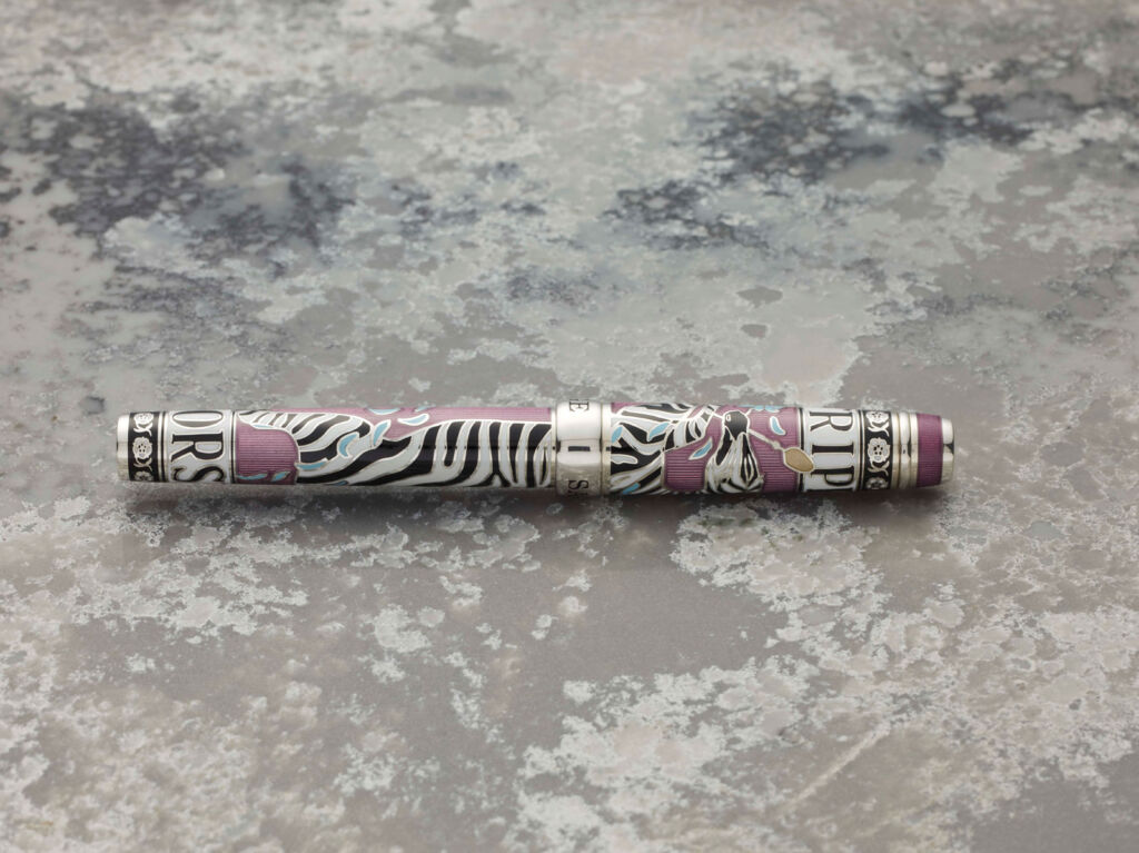 A side view of The Artist's Pen on a marble surface