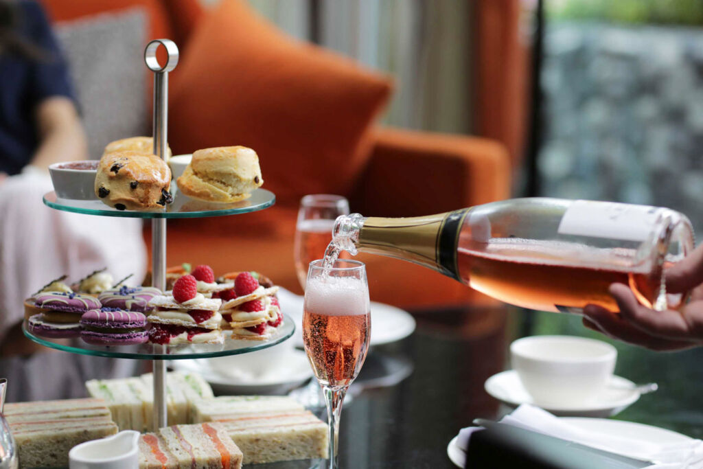 A bottle of bubbly being poured at the hotel's afternoon tea