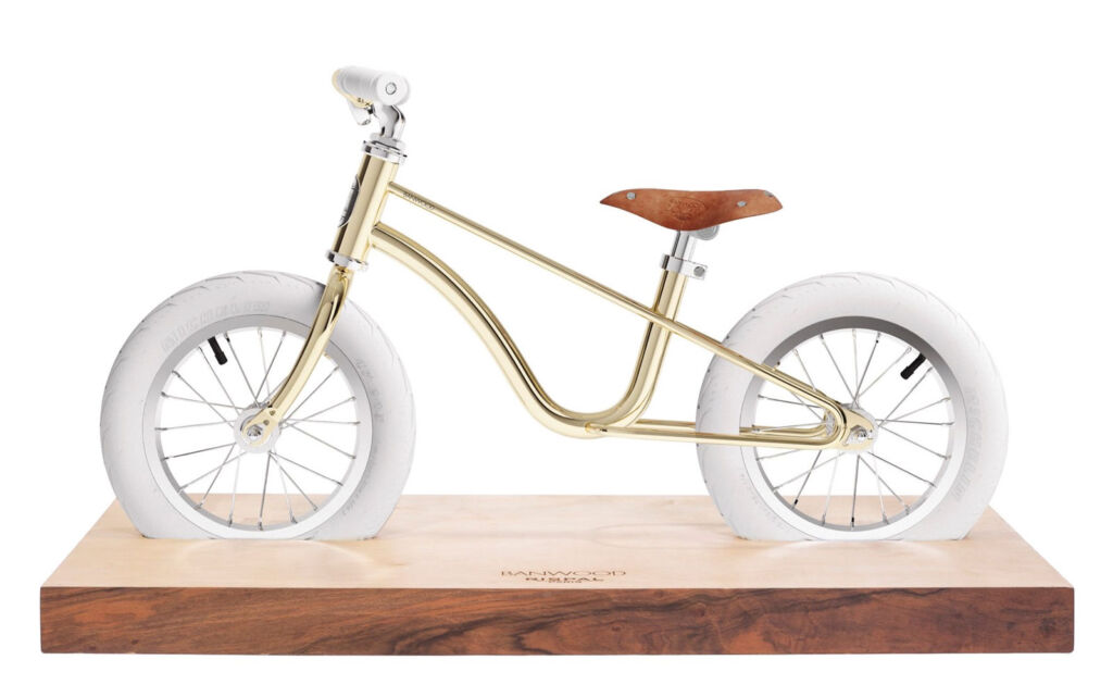 The Banwood X Rispal Balance Bike on a wooden display plinth
