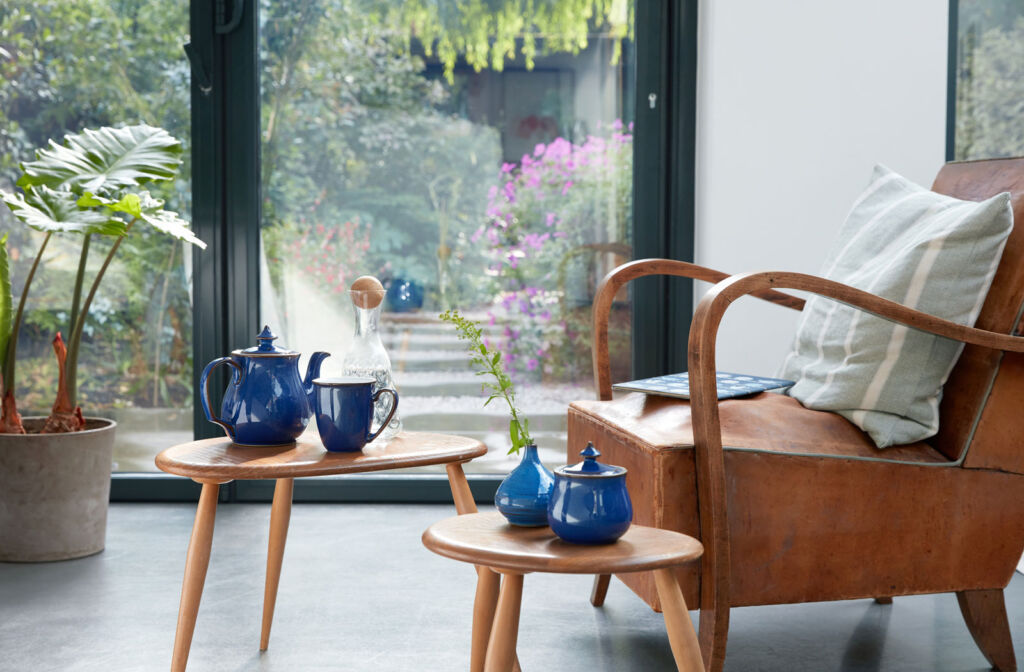 Some blue coloured Denby pottery next to sustainable furniture
