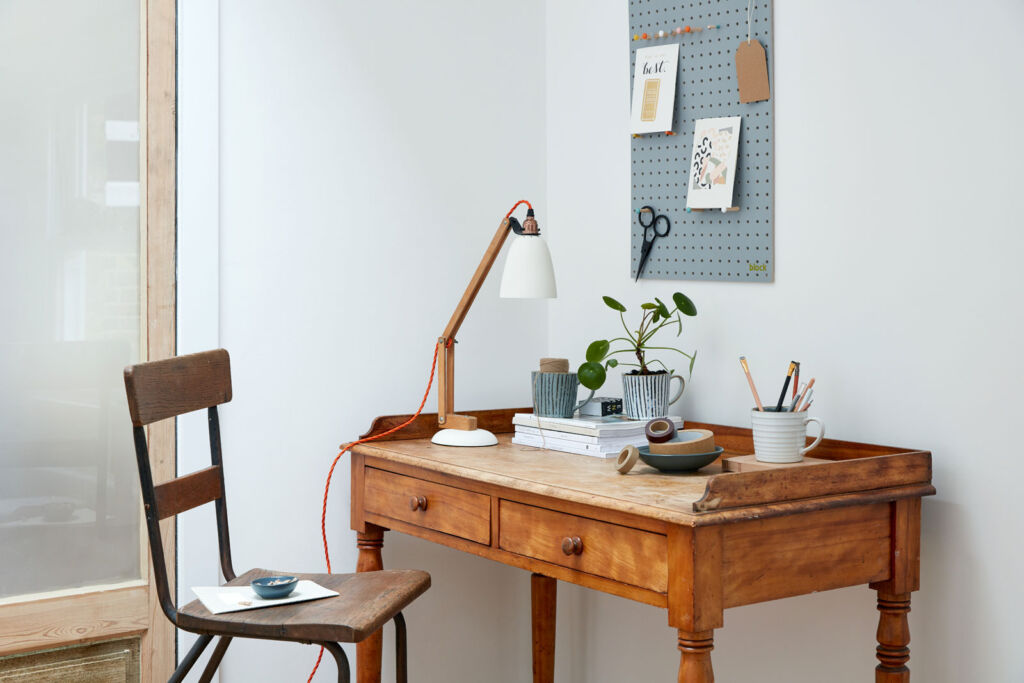 A well loved wooden desk in a home
