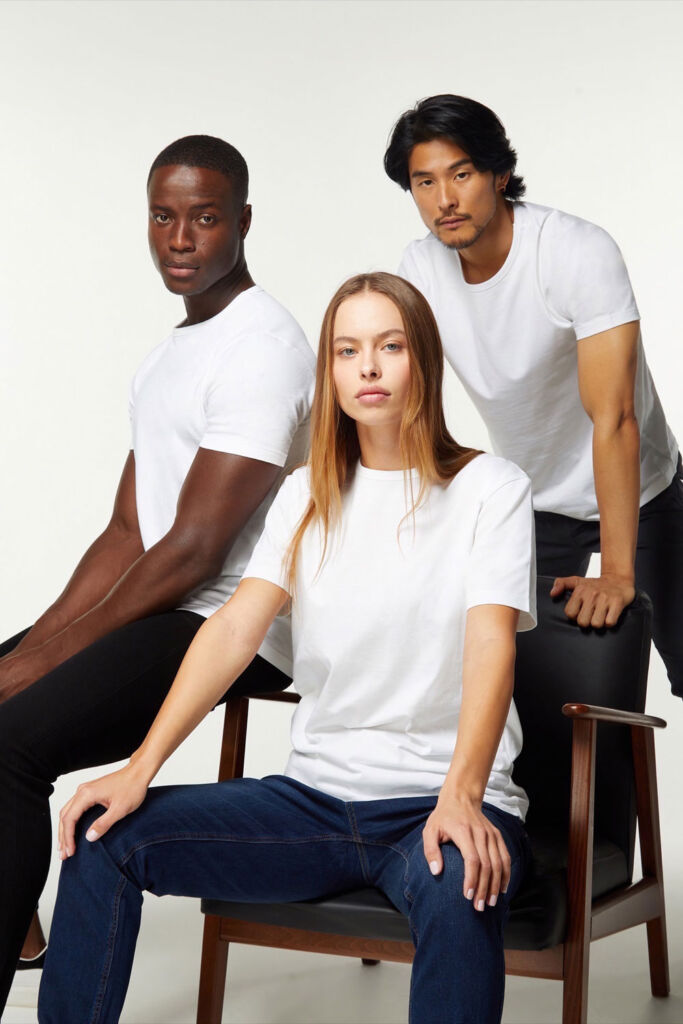 Models wearing the clothing while relaxing around a chair