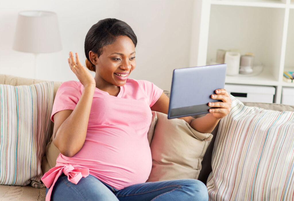 A pregnant woman relaxing on a sofa