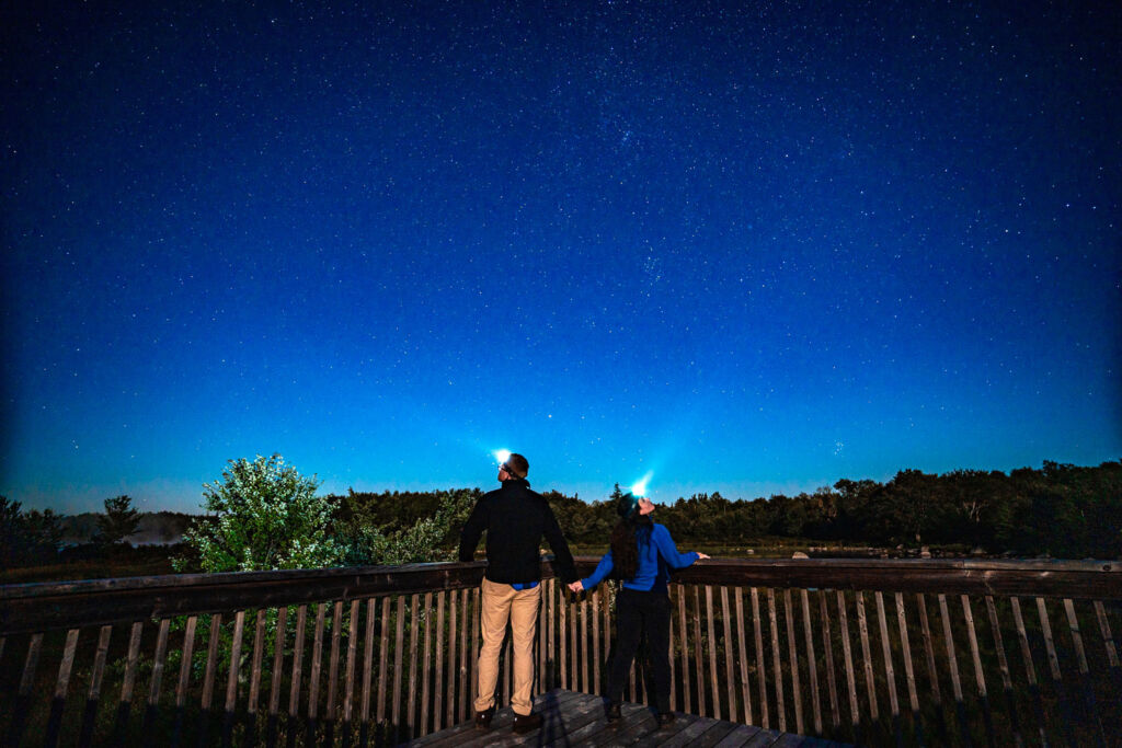 A couple enjoying the night sky at Trout Point Lodge