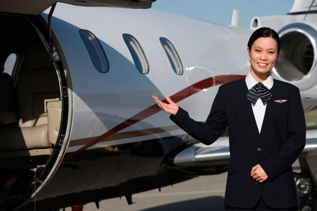 Woman inviting a guest onto a private jet