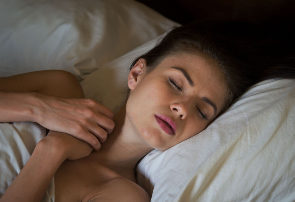 A woman sleeping in a darkened room