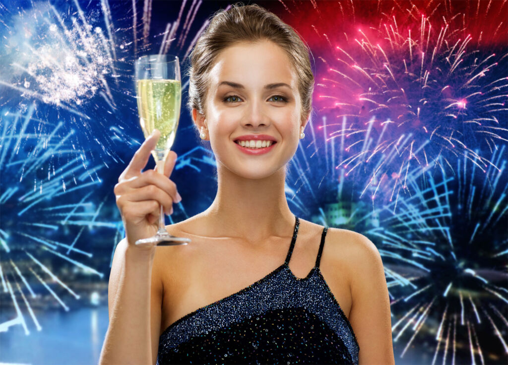 A young woman celebrating the festive season with a glass of bubbly