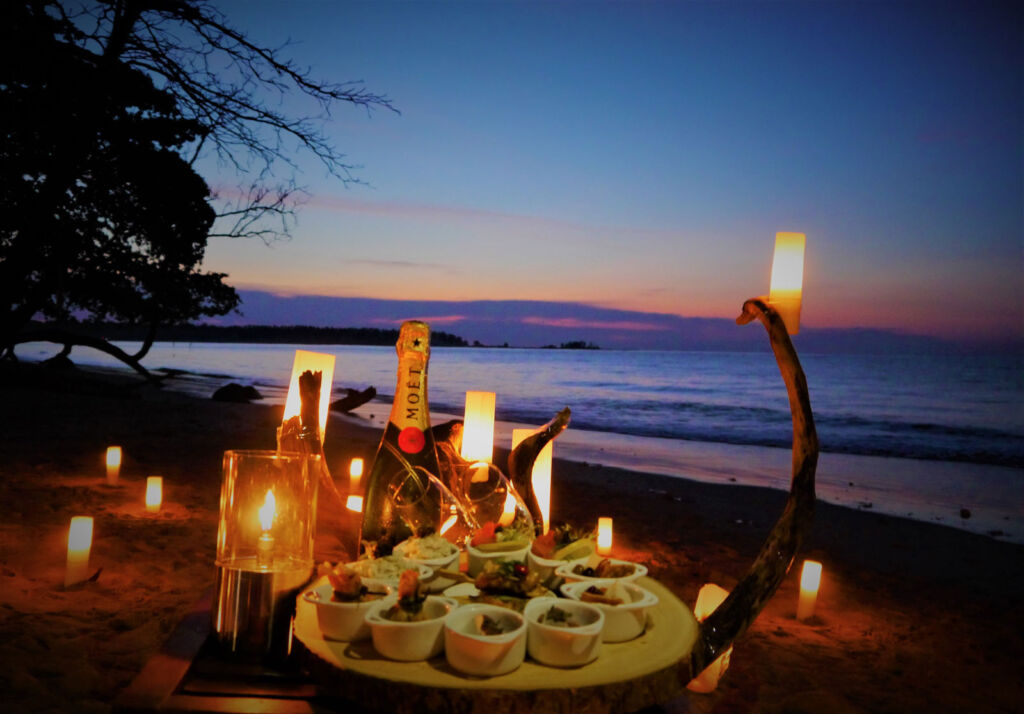 Champagne and canapes for two on a secluded beach