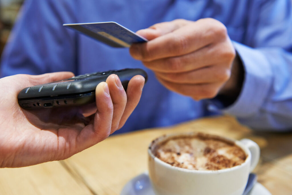 Person paying for a meal using contactless payment