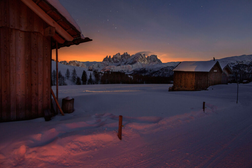 Outside two of the Trentino mountain huts at sunrise