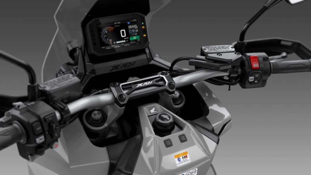 A closeup of the buttons and instrument panel on the Honda X-ADV
