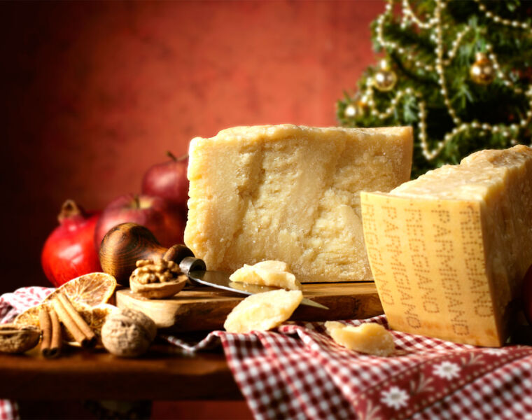 Parmigiano Reggiano cheese on a wooden board ready to eat in the Holiday Season