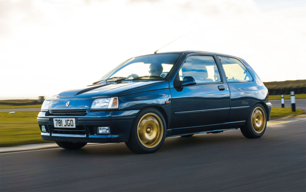 A Renault Clio Williams with gold alloys on the track