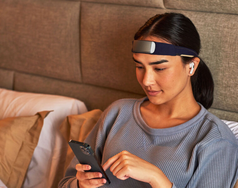 A woman using the Muse S Gen 2 headband in her bed