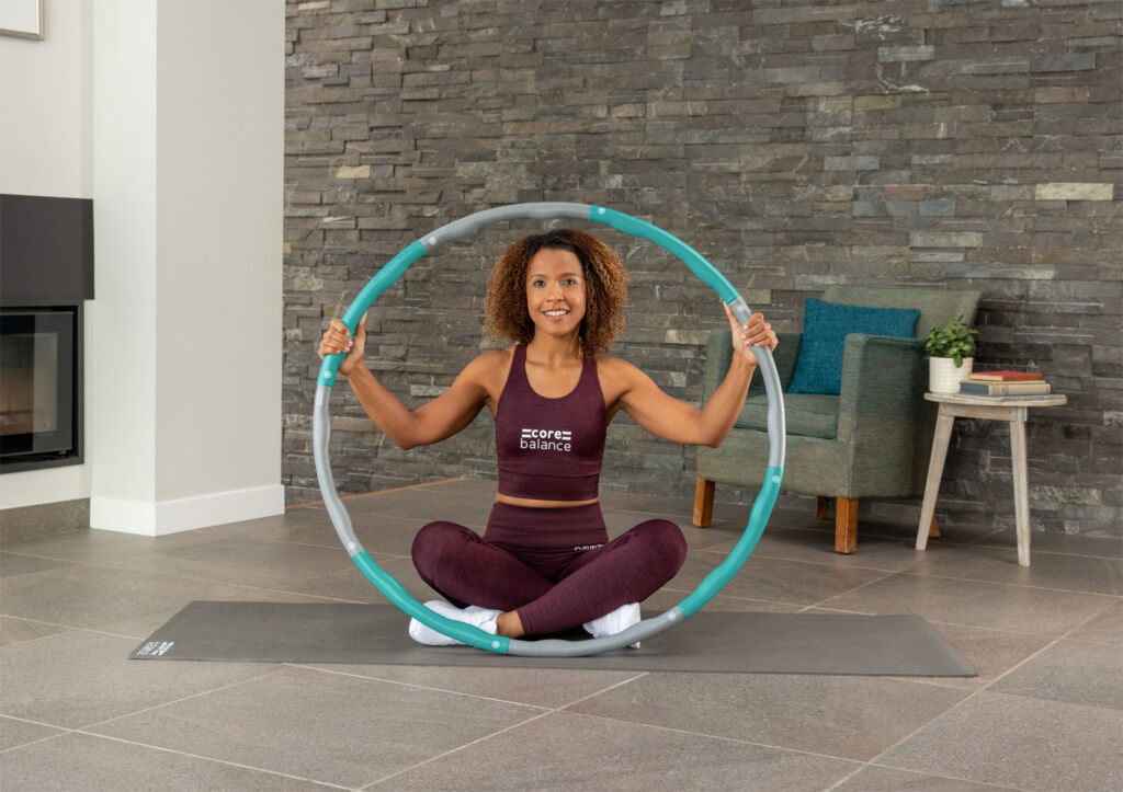 A woman ready to workout with Core Balance's Weighted Hula Hoop